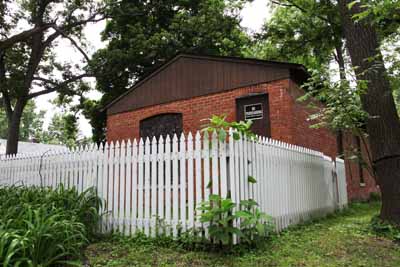 Here is the very front of the house with the fence in front of it.